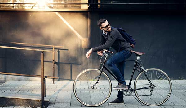 Young man riding bike through the Perth metro area