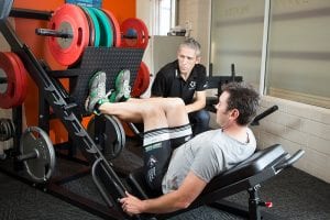Dr James Debenham supervising strength exercises for hip pain