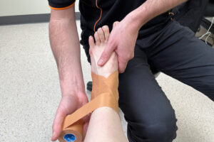 podiatrist taping ankle sprain sports injury treatment Perth