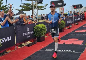 James Lewin completing an Ironman triathlon with expertise in running, cycling and endurance athlete physiotherapy