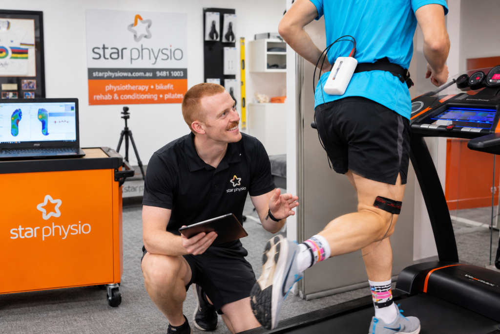 Star Physio physiotherapist Cillian Madden supervising a runner performing weighted calf raises during Achilles rehabilitation